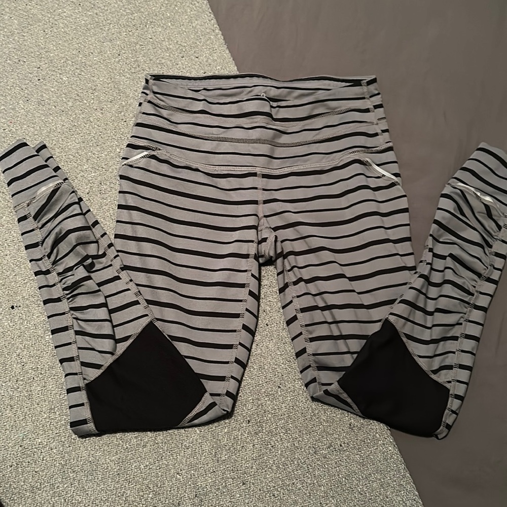 ATHLETA grey and black striped relay tight with reflective detail